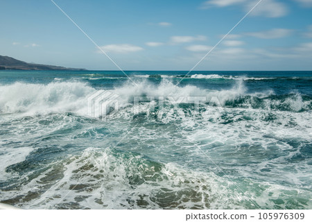 rough sea with a strong surge of white foam 105976309
