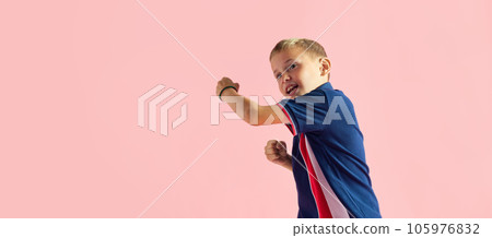 Portrait of playful little boy, child playing, fighting, boxing against pink studio background 105976832
