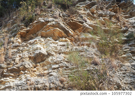 Flysch is a series of marine sedimentary rocks that are predominantly clastic in origin and are characterized by the alternation of lithological layers. Balkans, Montenegro, Zelenika, Herceg Novi. 105977302