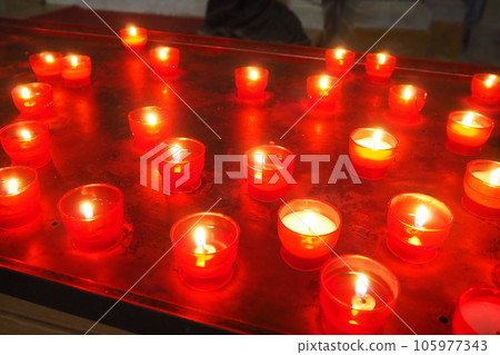 Memorial Day with candle. Commemorative candles are lit. Candle flames burn in the cemetery. Burning candles in the catholic church in Dubrovnik Croatia. Lots of candles. The flame sways in the draft 105977343