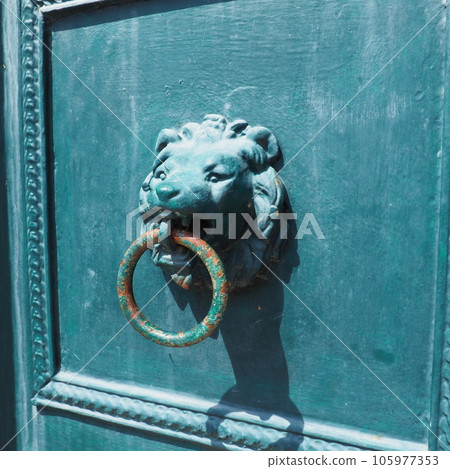 A door knocker is a fixture on the front door of a house. It is made of metal and has the form of a ring, which is knocked on the metal part of the door knocker fixed to the wall. Muzzle of a lion A door knocker is a fixture on the front door of a house. It is made of metal and has the form of a ring, which is knocked on the metal part of the door knocker fixed to the wall. Muzzle of a lion 105977353