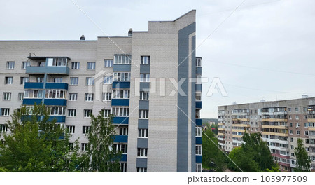 Beautiful facade of a brick house with balconies and a high sharp angle. Beautiful facade of a brick house with balconies and a high sharp angle. 105977509