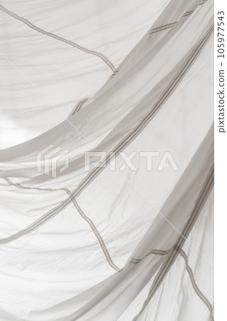 Segment of folded white parachute fabric closeup. Monochrome background with copy space for your design. 105977543