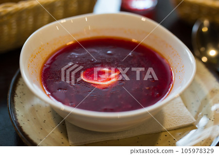 Beetroot soup with sour cream in bowl 105978329