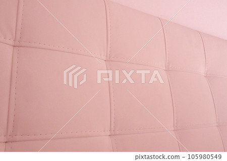 Soft headboard. Upholstery for furniture made of genuine or artificial leather and fabric. Soft headboard against a light wall Soft headboard. Upholstery for furniture made of genuine or artificial leather and fabric. Soft headboard against a light wall 105980549