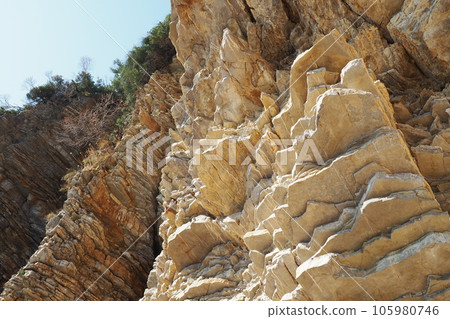 Flysch is a series of marine sedimentary rocks that are predominantly clastic in origin and are characterized by the alternation of lithological layers. Balkans, Montenegro, Budva, Mogren beach. 105980746