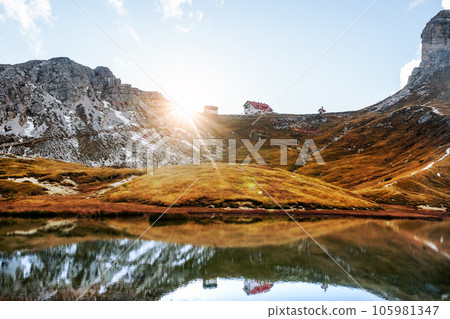 Rifugio Locatelli mirrored in clear turquoise water 105981347