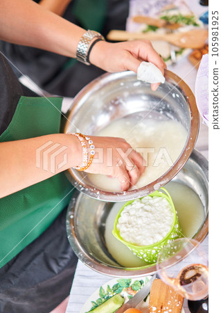 Master class and cheese tasting. Women make cheese. The enzyme and starter culture are added to the milk in a metal container. Milk folding process, home production, business, entrepreneur. Master class and cheese tasting. Women make cheese. The enzyme and starter culture are added to the milk in a metal container. Milk folding process, home production, business, entrepreneur. 105981925