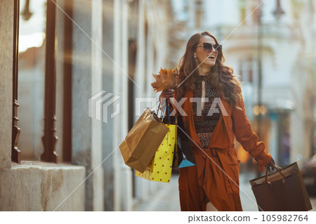 happy trendy woman in brown trench coat happy trendy woman in brown trench coat 105982764