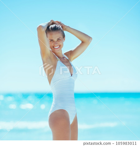 happy young woman on sea shore 105983011