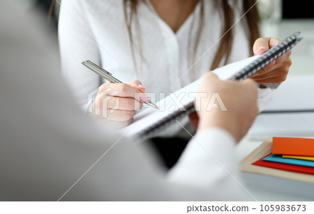Close-up of people sitting in office and writing something Close-up of people sitting in office and writing something 105983673