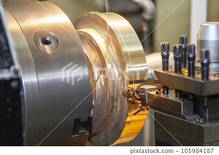 Closeup scene the lathe machine finish cut the brass parts by lathe tools. Closeup scene the lathe machine finish cut the brass parts by lathe tools. 105984187