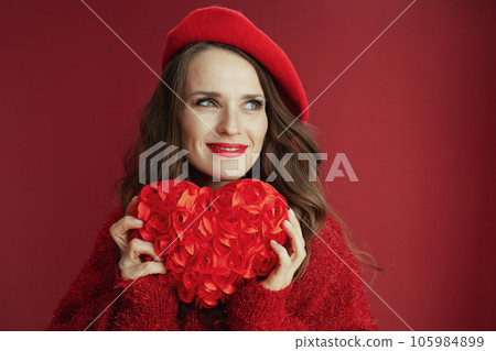 smiling elegant woman in red sweater and beret with red heart 105984899