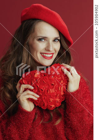smiling elegant woman in red sweater and beret 105984902