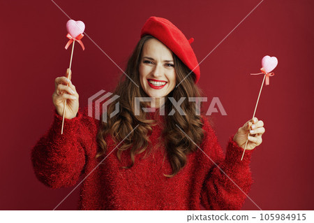 smiling modern 40 years old woman in red sweater and beret 105984915