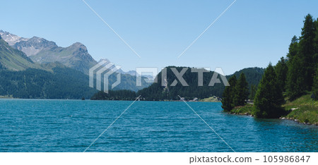 Mountain landscape, lake and mountain range, large panorama. Panoramic view of beautiful mountain landscape in Alps with Silsersee lake Mountain landscape, lake and mountain range, large panorama. Panoramic view of beautiful mountain landscape in Alps with Silsersee lake 105986847