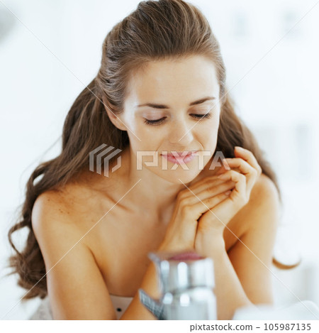 relaxed young woman in bathroom 105987135