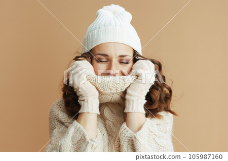 relaxed elegant woman on beige background wrapped in collar relaxed elegant woman on beige background wrapped in collar 105987160