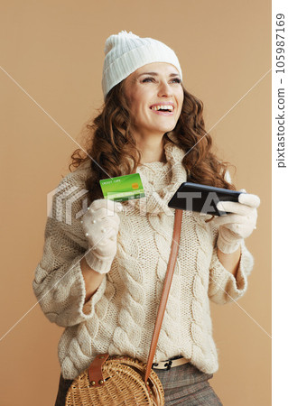 smiling trendy woman isolated on beige browsing online shop smiling trendy woman isolated on beige browsing online shop 105987169