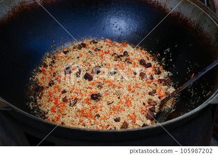 Pilaf cooking on a fire. 105987202