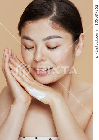 modern asian woman with hand cream 105987552