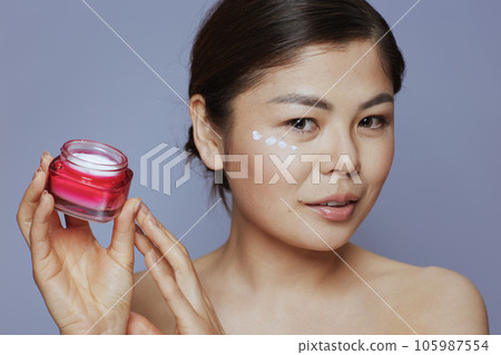 modern asian female with facial cream jar modern asian female with facial cream jar 105987554