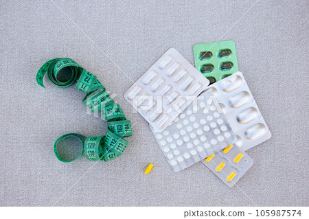 Slimming pills and measuring tape. Diet. Slimming pills and measuring tape. Diet. 105987574