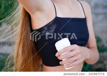 A white deodorant stain on a black t-shirt. A white deodorant stain on a black t-shirt. 105987578