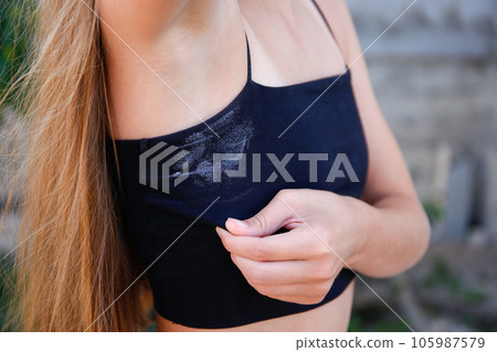 A white deodorant stain on a black t-shirt. A white deodorant stain on a black t-shirt. 105987579