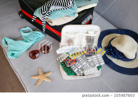 Summer beach accessories for your sea holiday and pills. Concept of medication required in journey. Summer beach accessories for your sea holiday and pills. Concept of medication required in journey. 105987603