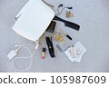 White handbag open with pills and women's accessories. 105987609
