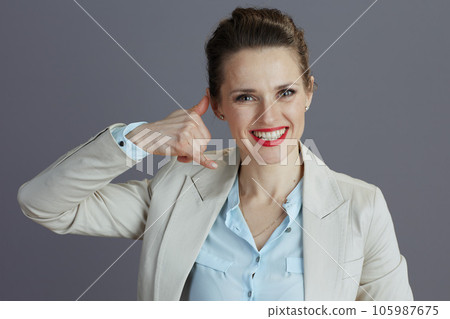smiling stylish female employee showing call me gesture 105987675