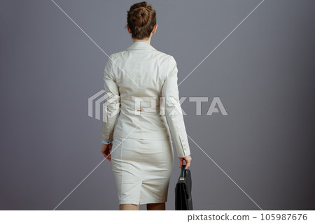 trendy female employee in light business suit walking 105987676