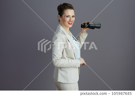 happy young female employee in light business suit 105987685