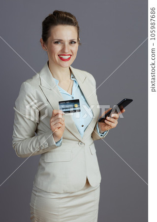 smiling 40 years old woman employee in light business suit smiling 40 years old woman employee in light business suit 105987686