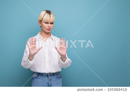 young beautiful blond office worker woman with a bob hairstyle and dressed in a white shirt refuses 105988410