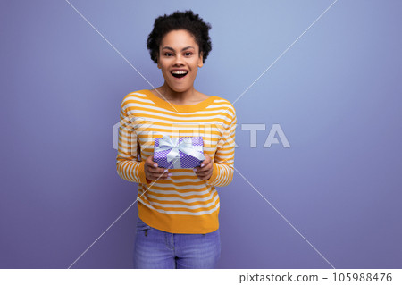 surprised afro brunette 20s latin young woman with gift box 105988476