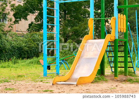 Summer spring children's playground with painted toy slide in park 105988743