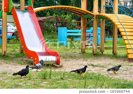 Summer spring children's playground with painted toy slide in park 105988744