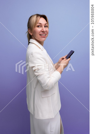 pretty slim young caucasian blondie lady in a white jacket and dress on a plain background pretty slim young caucasian blondie lady in a white jacket and dress on a plain background 105988804