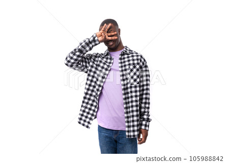 portrait of attractive dark skinned man in plaid shirt and jeans posing over isolated white portrait of attractive dark skinned man in plaid shirt and jeans posing over isolated white 105988842