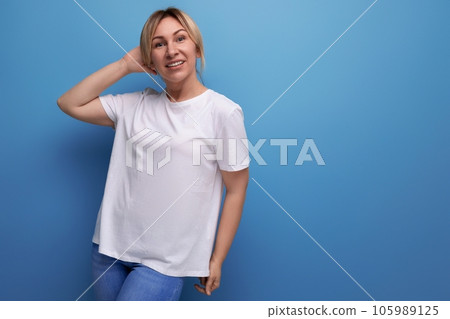 blond young lady in white tank top for business logo print on studio background with copy space blond young lady in white tank top for business logo print on studio background with copy space 105989125