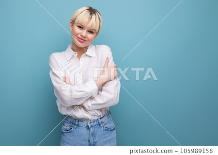 young caucasian woman with a short haircut is dressed in a white shirt on background with copy space 105989158