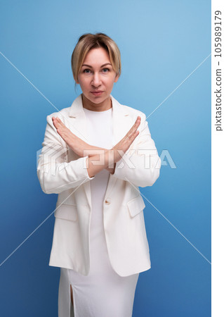 young well-groomed blond boss woman in a white jacket crossed her arms young well-groomed blond boss woman in a white jacket crossed her arms 105989179