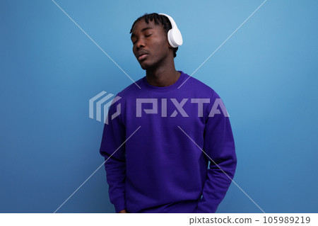 african young brunette male with dreadlocks with wireless headphones 105989219
