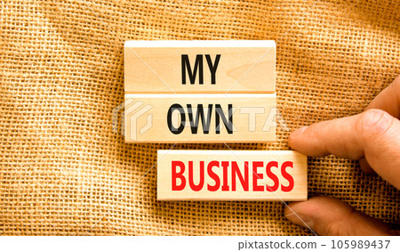 My own business symbol. Concept words My own business on wooden block. Beautiful canvas table canvas background. Businessman hand. Business motivational my own business concept. Copy space. My own business symbol. Concept words My own business on wooden block. Beautiful canvas table canvas background. Businessman hand. Business motivational my own business concept. Copy space. 105989437