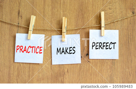 Practice makes perfect symbol. Concept words Practice makes perfect on beautiful white paper on clothespin. Beautiful wooden background. Business practice makes perfect concept. Copy space. 105989483