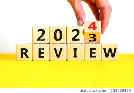2024 review new year symbol. Businessman turns a wooden cube and changes words Review 2023 to Review 2024. Beautiful white background, copy space. Business 2024 review new year concept. 2024 review new year symbol. Businessman turns a wooden cube and changes words Review 2023 to Review 2024. Beautiful white background, copy space. Business 2024 review new year concept. 105989489