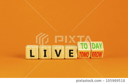 Live today not tomorrow symbol. Businessman turns wooden cubes and changes word Live tomorrow to Live today. Beautiful orange background. Business and live today not tomorrow concept. Copy space. Live today not tomorrow symbol. Businessman turns wooden cubes and changes word Live tomorrow to Live today. Beautiful orange background. Business and live today not tomorrow concept. Copy space. 105989518
