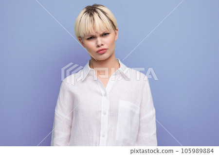 young confident caucasian blond career woman in white blouse looking at camera friendly 105989884